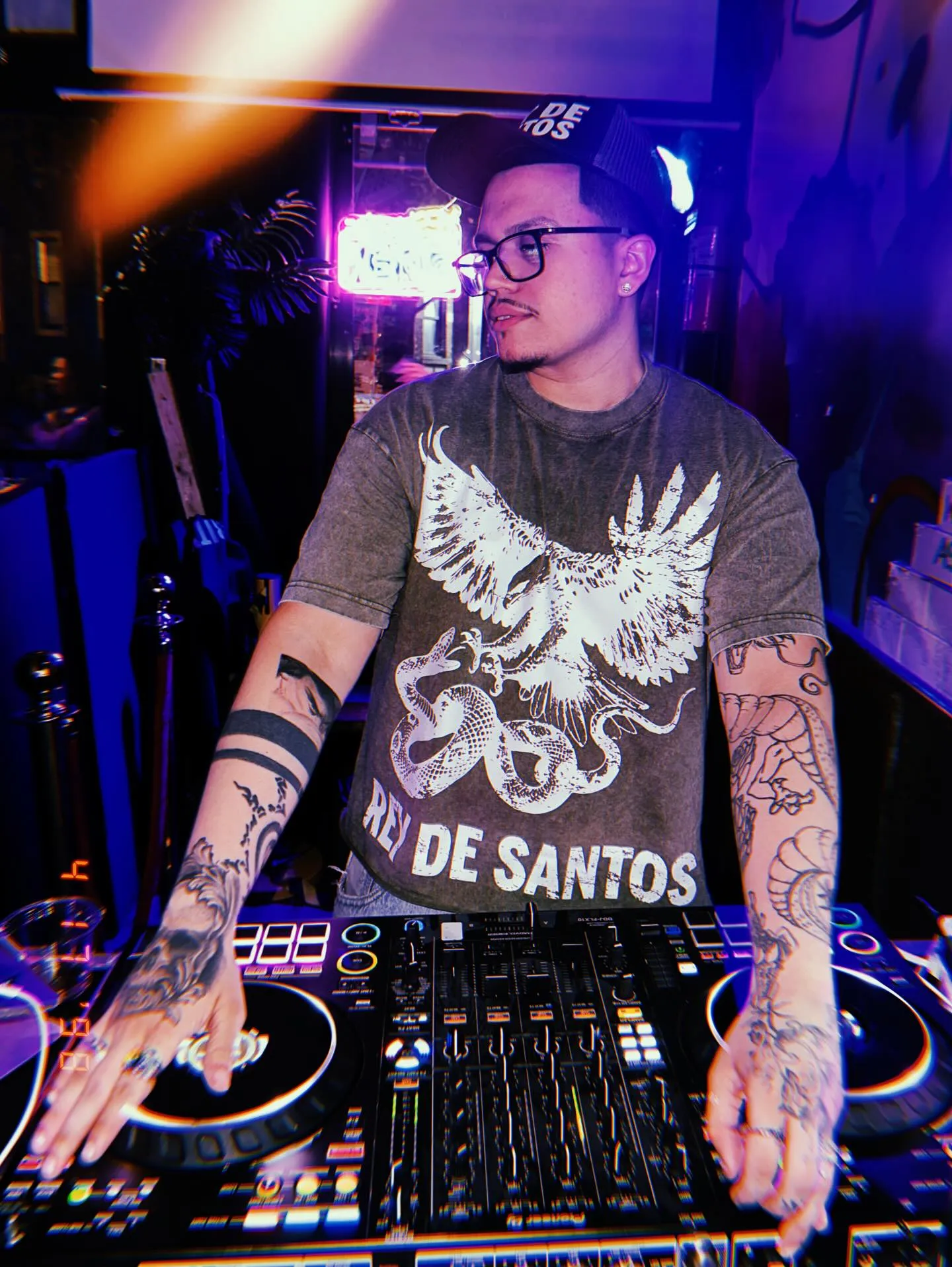 Mannix behind the decks under blue and orange lights