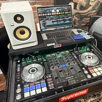 DJ controller setup with speaker and laptop